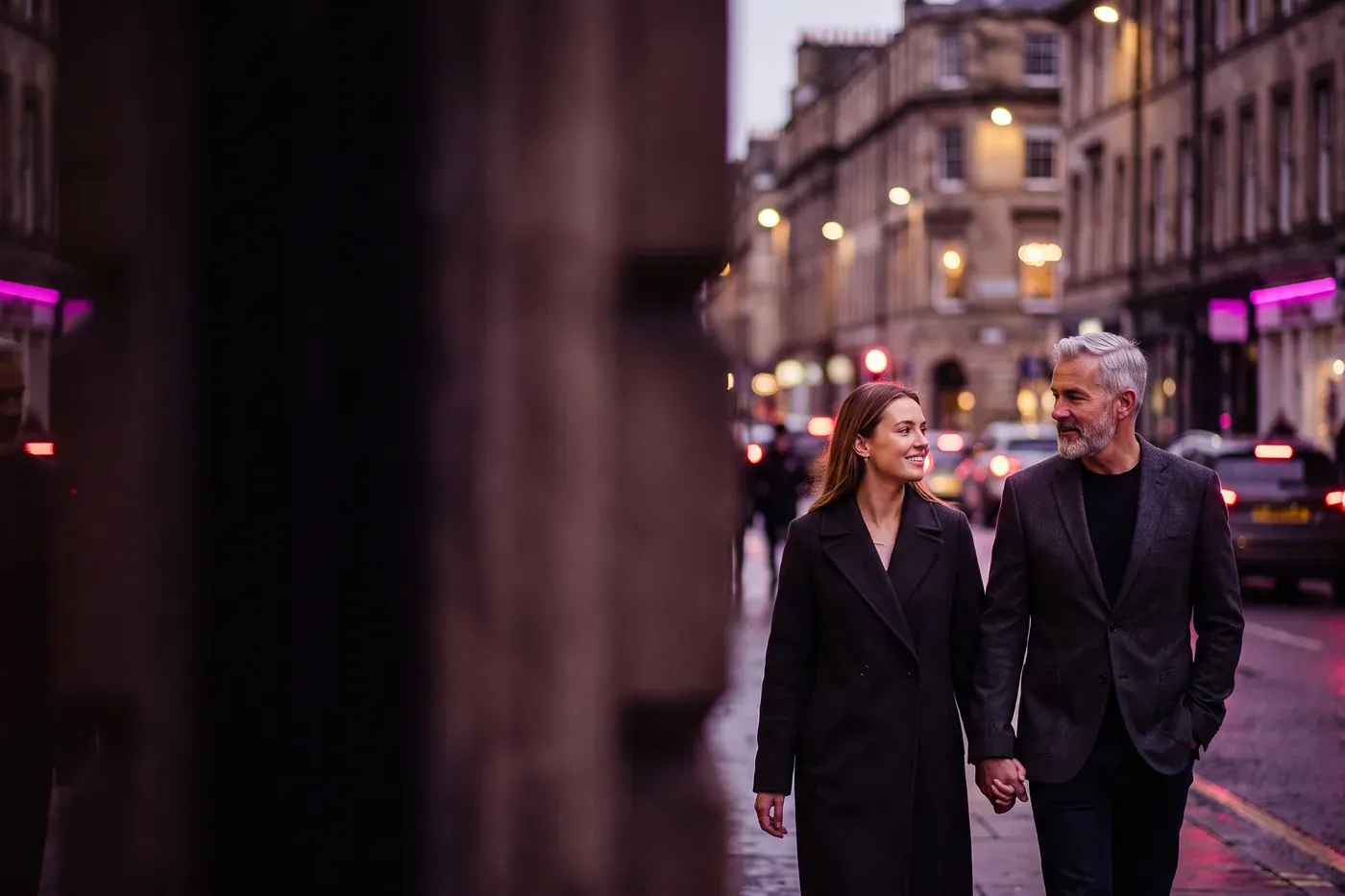 A confident adult age-gap couple walking forward together.